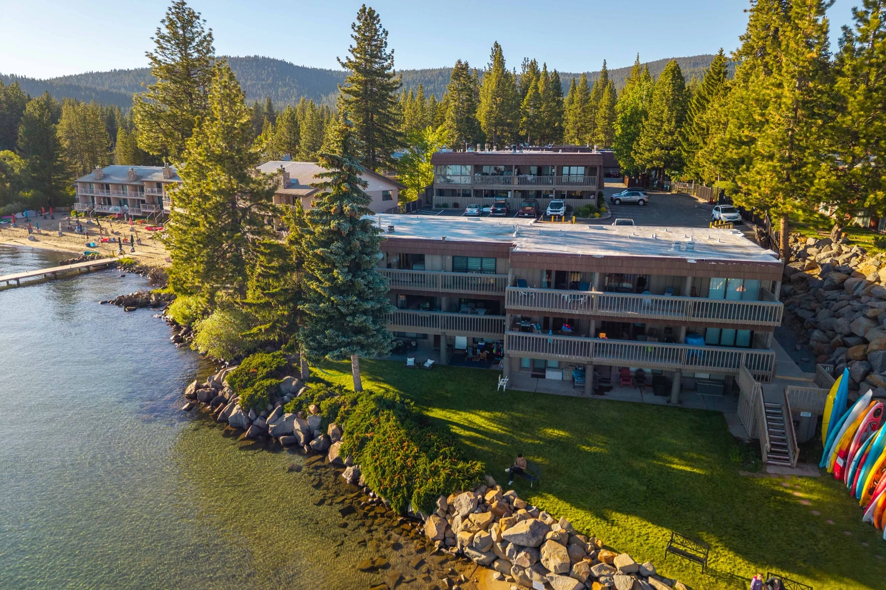 Aerial view of lakefront condo building and shoreline