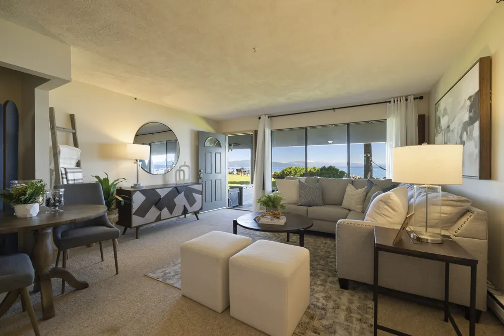 Living room with panoramic Lake Tahoe view through floor-to-ceiling windows