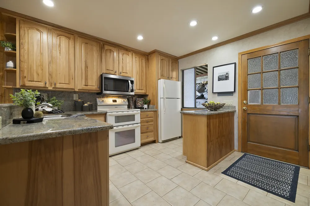 Full kitchen with hickory cabinetry, granite counters and double oven
