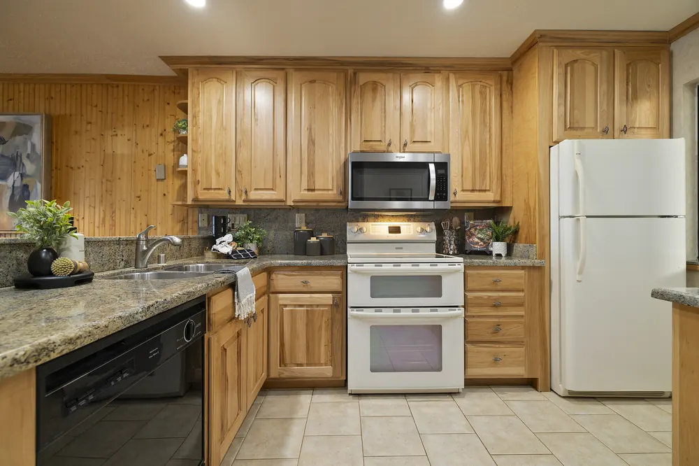 Kitchen detail with granite counters, microwave and ample storage